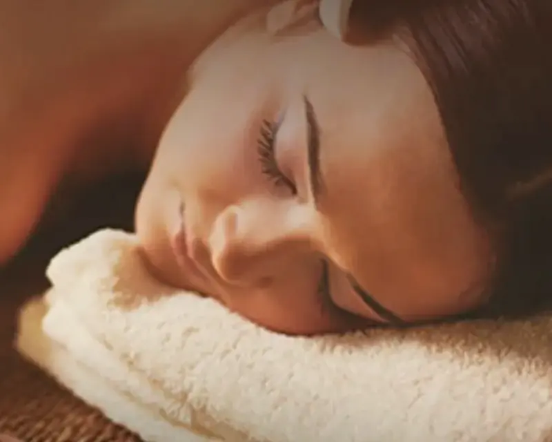 Cliente relaxando durante a massagem com pedras quentes